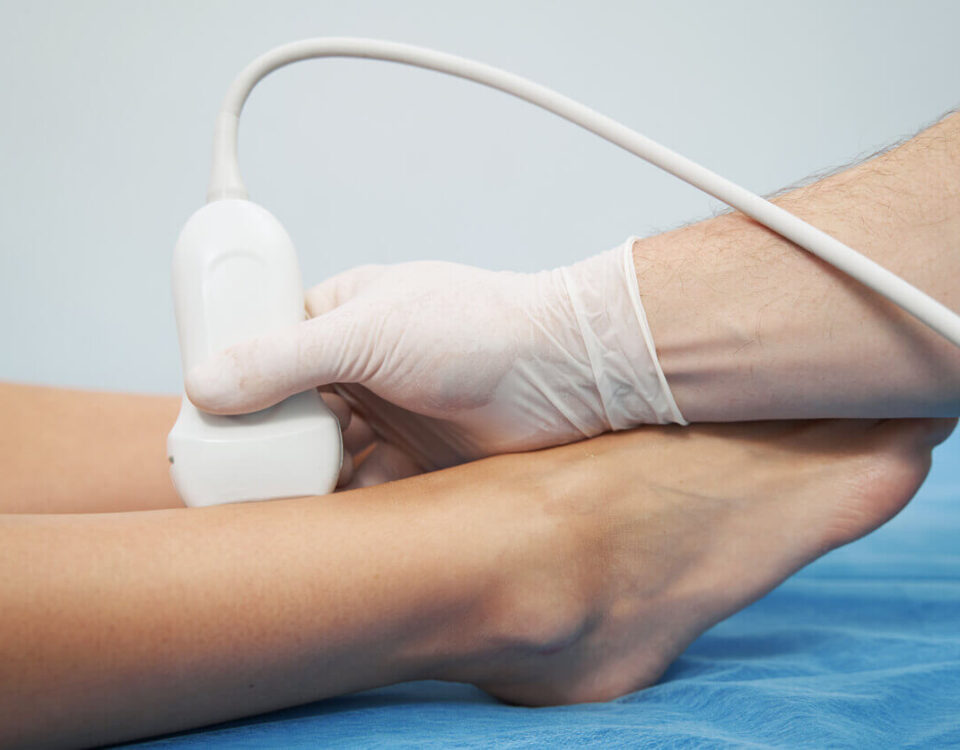 image showing a healthcare professional performing a vein health screening using ultrasound technology on a patient.